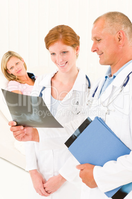 Medical doctors look x-ray patient broken arm