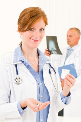 Medical doctor team young woman hold pills