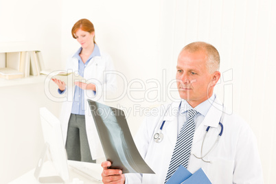 Medical doctor team male look at x-ray