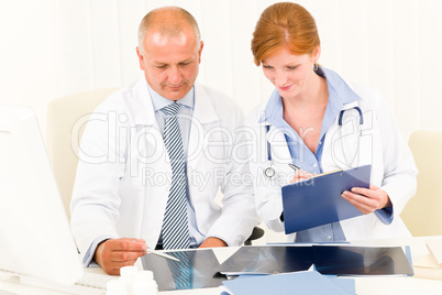 Medical doctor team look point at x-ray