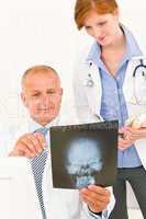 Medical team doctors look at head x-ray