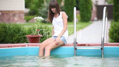 Pretty girl  swimming in the pool