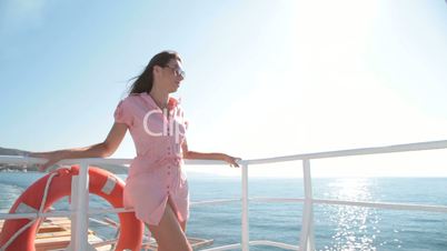 young woman relaxing on the deck of  ship
