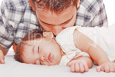 Father kissing his baby sleeping