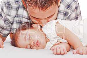 Father kissing his baby sleeping