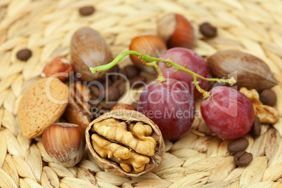 nuts and grapes on a wicker mat