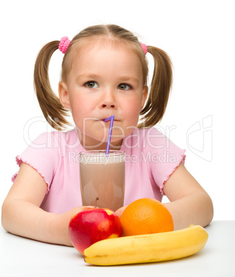 Little girl drinks fruit juice