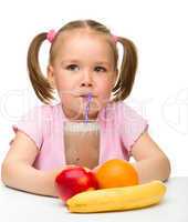Little girl drinks fruit juice