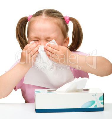 Little girl blows her nose