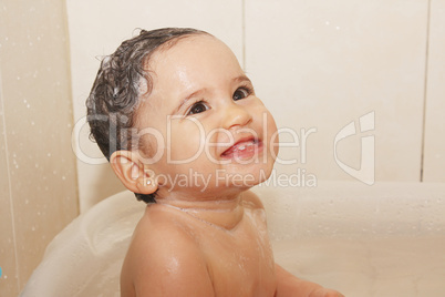 litlle baby bathes in a bathroom