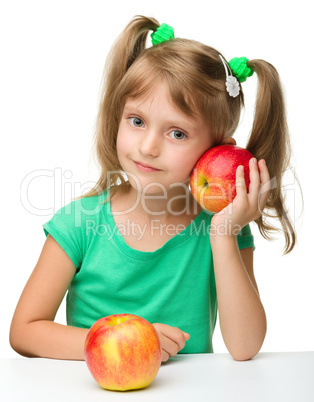 Portrait of a little girl with two apples