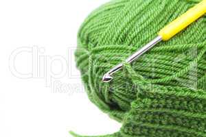 Skein of wool, crochet hook  and knitted piece isolated on white