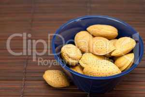 almonds in a bowl on a bamboo mat