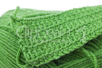 Skein of wool  and knitted piece isolated on white