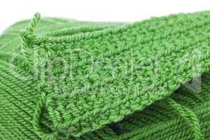 Skein of wool  and knitted piece isolated on white