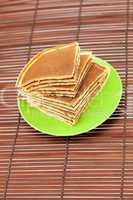 Pancakes on a plate on a bamboo mat