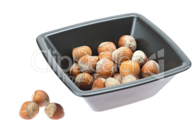 hazelnuts in a bowl isolated on white