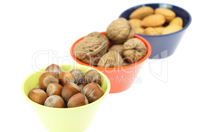 nuts in bowls isolated on white