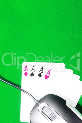 An online gaming concept with computer mouse, four aces and gree