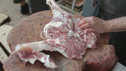 Cutting with knife tendon connecting the tibia on mutton leg