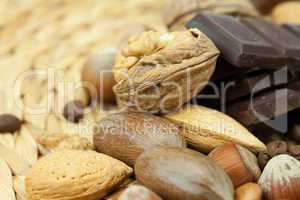 bar of chocolate and nuts on a wicker mat