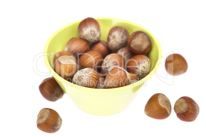 hazelnuts in a bowl isolated on white