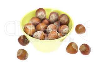 hazelnuts in a bowl isolated on white