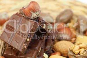 bar of chocolate and nuts on a wicker mat