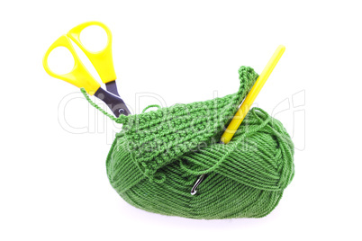 skein of wool with scissors and crochet hooks isolated on white