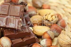 bar of chocolate and nuts on a wicker mat