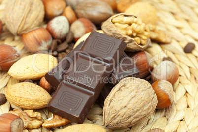 bar of chocolate and nuts on a wicker mat