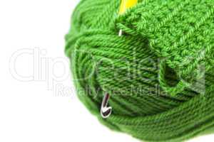 Skein of wool, crochet hook  and knitted piece isolated on white