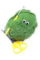 skein of wool  with eyes, scissors and crochet hooks isolated on