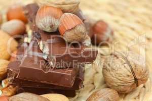 bar of chocolate and nuts on a wicker mat