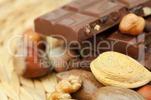 bar of chocolate and nuts on a wicker mat