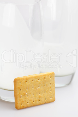 two glasses of milk and cookies on a gray background