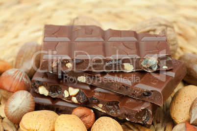 bar of chocolate and nuts on a wicker mat