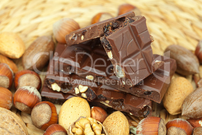 bar of chocolate and nuts on a wicker mat