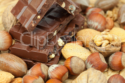 bar of chocolate and nuts on a wicker mat