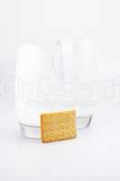 two glasses of milk and cookies on a gray background
