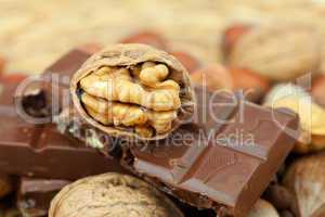 bar of chocolate and nuts on a wicker mat