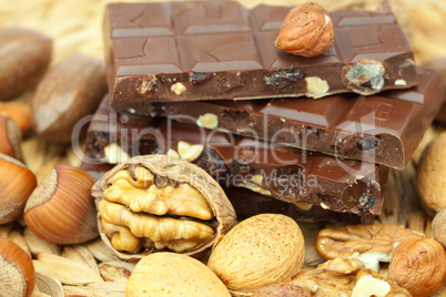 bar of chocolate and nuts on a wicker mat