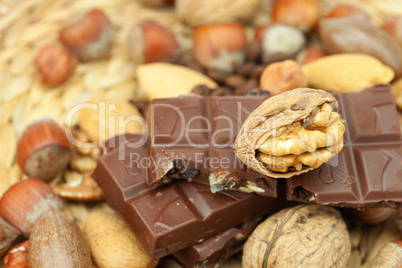 bar of chocolate and nuts on a wicker mat