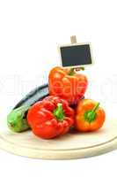 red peppers, eggplant and board on a cutting board isolated on w