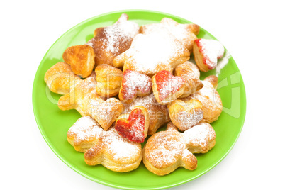 cookies with powdered sugar on a plate isolated on white