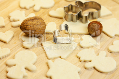 cut dough snowman, house, nuts, heart and forms for the cookies