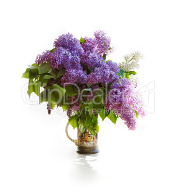 Bouquet of a lilac in a bright jar on light tones.