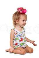 Little girl with pink hair curlers on her head
