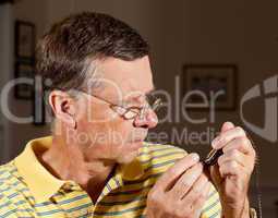 Senior repairing pocket watch