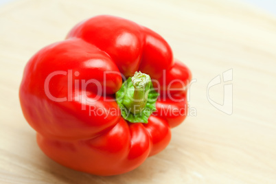 red pepper on a cutting board isolated on white